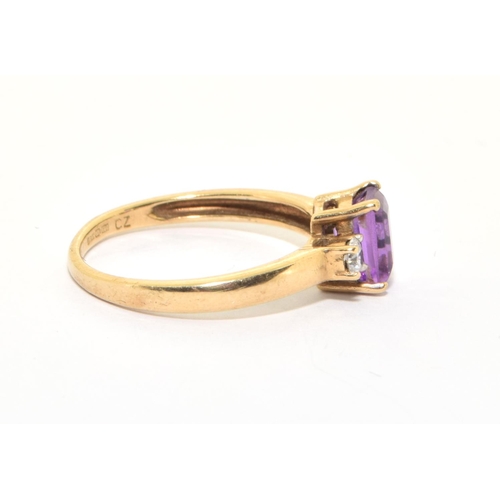 141 - 9ct gold ladies good emerald cut Amethyst solitaire with clear stone decoration size P