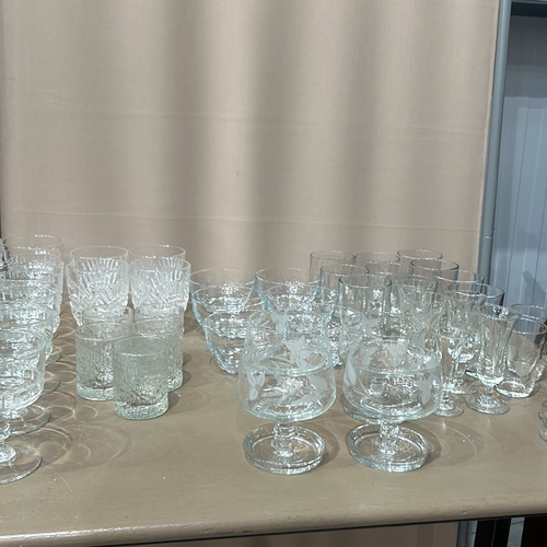 332 - Large quantity of assorted glassware, featuring intricate etched designs. Comprises various sizes an... 