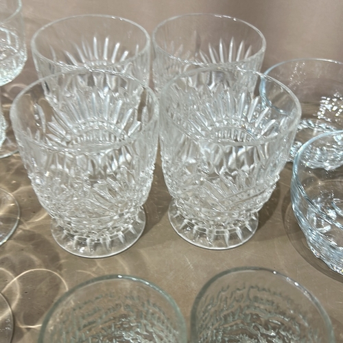 332 - Large quantity of assorted glassware, featuring intricate etched designs. Comprises various sizes an... 