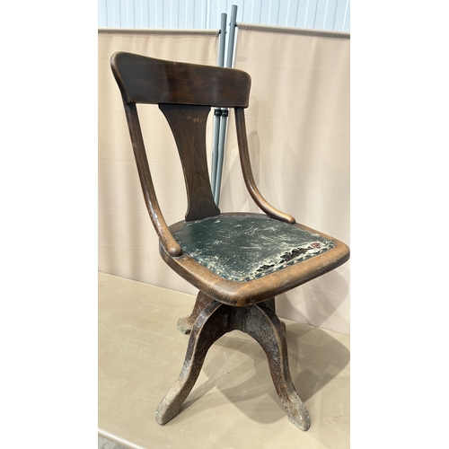 117 - Antique wooden swivel chair with a curved backrest, made from oak, featuring a distressed leather se... 