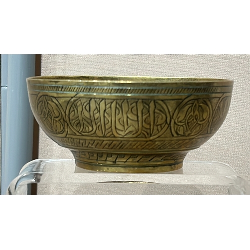 250 - A Collection of Persian/Indian Engraved brass items and a metal tray with six decorative bowls, feat... 