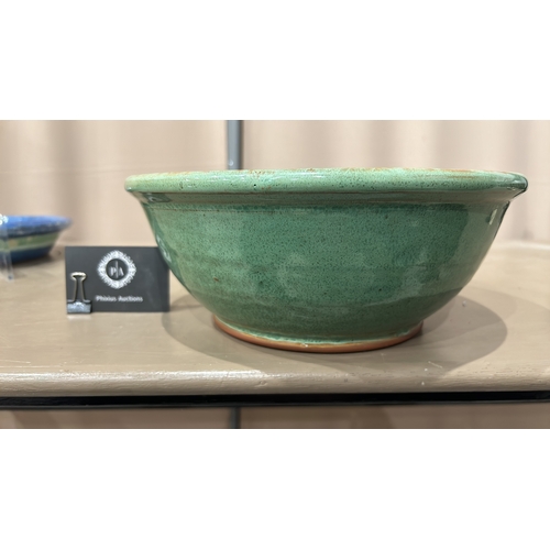 213 - 2 Large Studio Pottery bowls in blue and green glaze feature a spiral design inside.