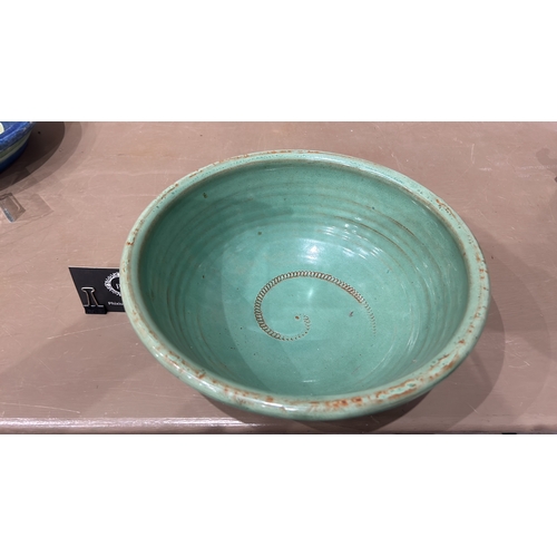 213 - 2 Large Studio Pottery bowls in blue and green glaze feature a spiral design inside.