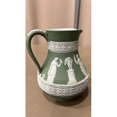 214 - A Beautiful Wedgwood Green Jasperware pitcher with classical relief scenes, featuring figures and fl... 