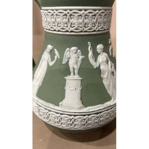 214 - A Beautiful Wedgwood Green Jasperware pitcher with classical relief scenes, featuring figures and fl... 