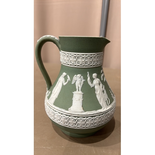 214 - A Beautiful Wedgwood Green Jasperware pitcher with classical relief scenes, featuring figures and fl... 