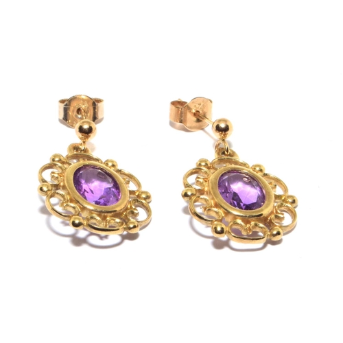 123 - 9ct gold Amethyst stud earrings in an openwork scroll setting 