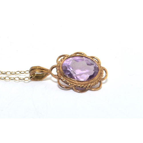 213 - 9ct gold Amethyst pendant necklace in an open scroll setting on a 46cm long chain 