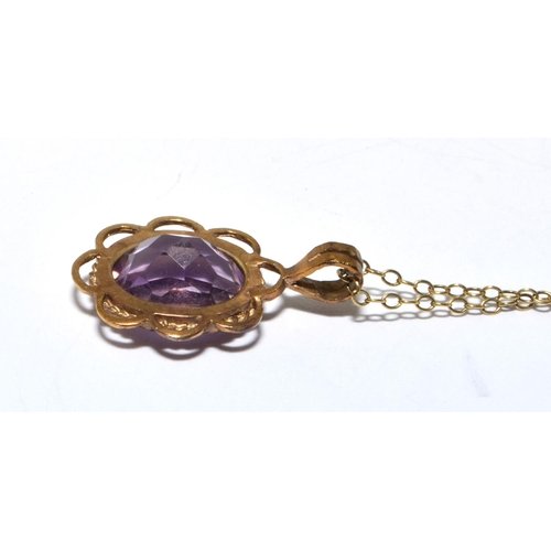 213 - 9ct gold Amethyst pendant necklace in an open scroll setting on a 46cm long chain 