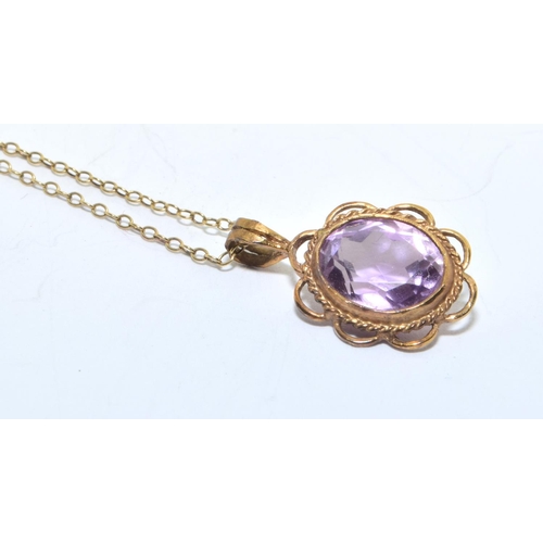 213 - 9ct gold Amethyst pendant necklace in an open scroll setting on a 46cm long chain 