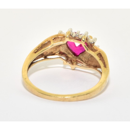 158 - 9ct gold ladies diamond heart design ring with a red Rubellite love heart centre stone size O