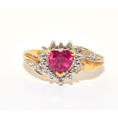 158 - 9ct gold ladies diamond heart design ring with a red Rubellite love heart centre stone size O