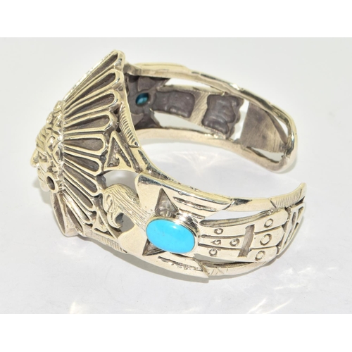 274 - Substantial silver cuff bangle in the form of a native indian set with turquoise cabachons