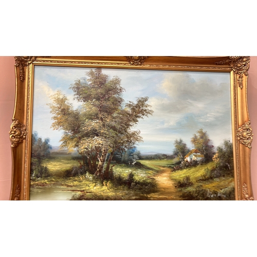 180 - Large gilt framed Oil painting signed by artist. Features a detailed landscape scene with lush green... 