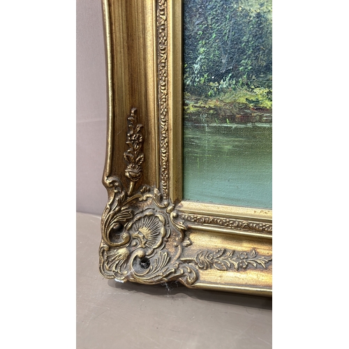 180 - Large gilt framed Oil painting signed by artist. Features a detailed landscape scene with lush green... 