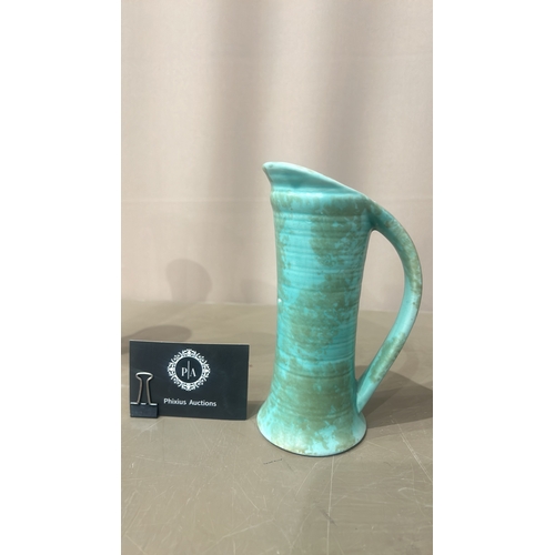 216 - Vintage Turquoise ceramic pitchers, featuring an Art Deco style with sleek geometric handles. From t... 