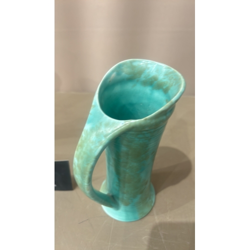 216 - Vintage Turquoise ceramic pitchers, featuring an Art Deco style with sleek geometric handles. From t... 