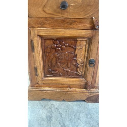 290 - Wooden bed side cabinet featuring Hand-carved intricate elephant motifs central panel. Indian Hard W... 