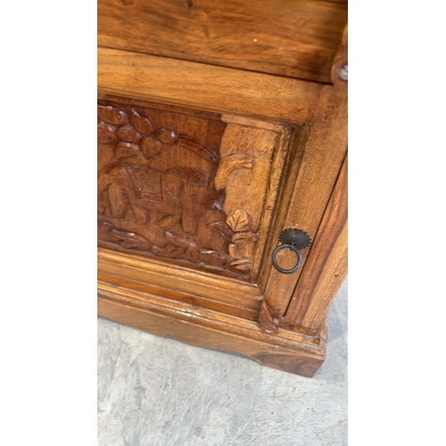 290 - Wooden bed side cabinet featuring Hand-carved intricate elephant motifs central panel. Indian Hard W... 