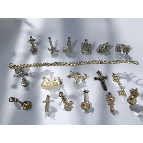 539 - A collection of silver & lead charms.