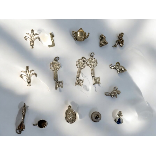 543 - 16 various Silver charms.