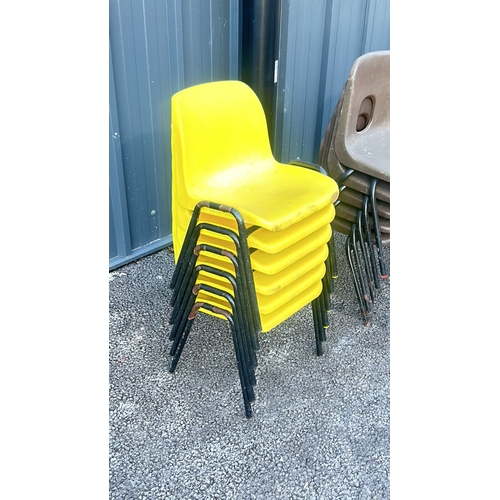 59 - Set of 21 small stackable plastic chairs in vibrant yellow, brown, blue, and red with black metal le... 