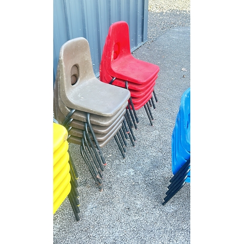 59 - Set of 21 small stackable plastic chairs in vibrant yellow, brown, blue, and red with black metal le... 