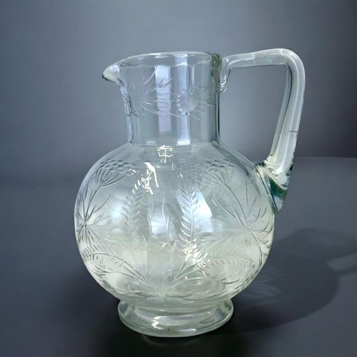 569 - Christopher Dresser for James Powell & sons jug.Circa 1875.Engraved foliate designs. This jug ca... 