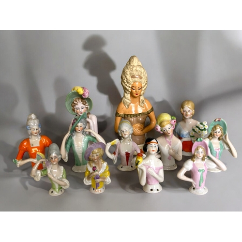 321 - A collection of 12 antique porcelain half doll toppers.