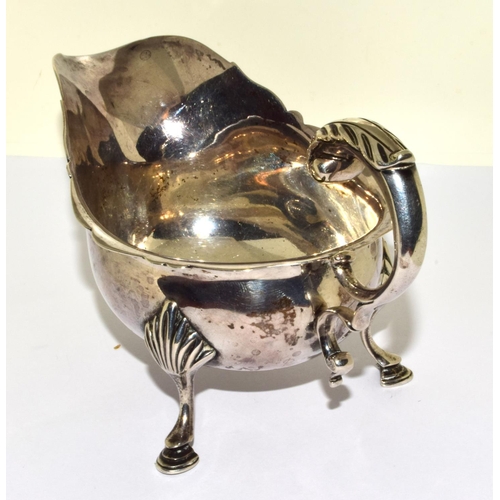 9 - Solid silver hallmarked 3 leg sauce boat set on hoof feet with a scroll handle 170grm