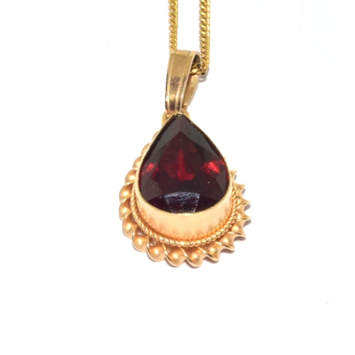 251 - 9ct gold Garnet pear shape pendant necklace in an enclosed setting on a 44cm long chain 