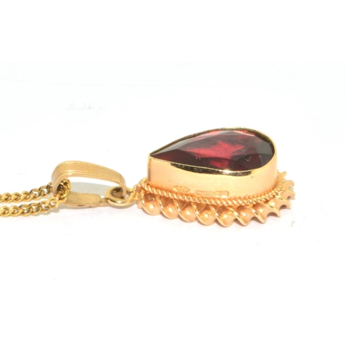 251 - 9ct gold Garnet pear shape pendant necklace in an enclosed setting on a 44cm long chain 