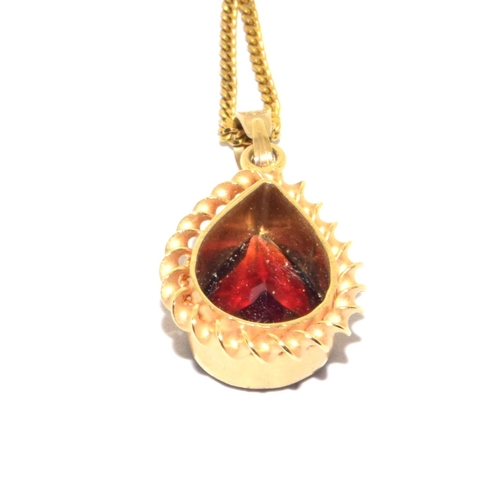 251 - 9ct gold Garnet pear shape pendant necklace in an enclosed setting on a 44cm long chain 