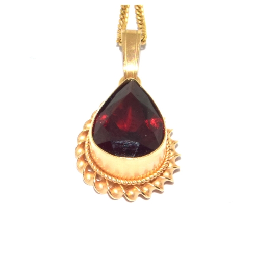 251 - 9ct gold Garnet pear shape pendant necklace in an enclosed setting on a 44cm long chain 