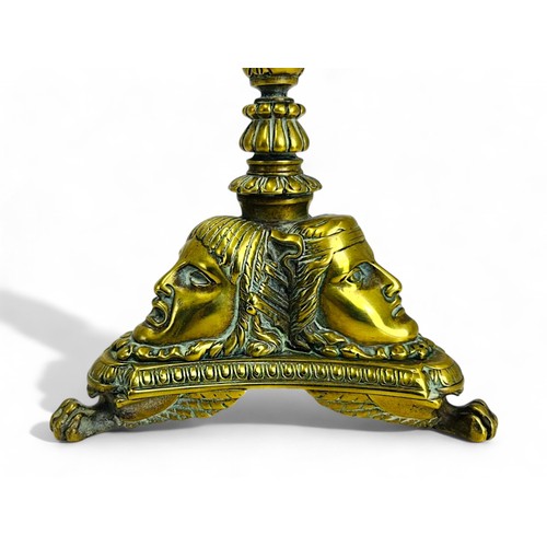 329 - A Grand Tour gilt bronze candlestick.France, 19th century.Sat on three winged Lion paw feet, with st... 