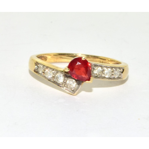 296 - 9ct gold ladies vintage Diamond and Ruby cross over ring size N