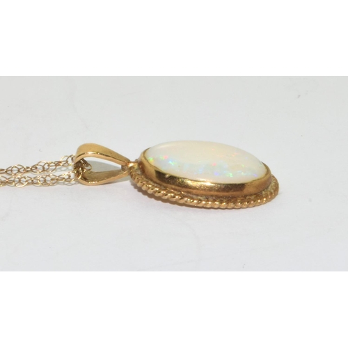 358 - 9ct gold large Opal oval pendant necklace set in a scroll setting on a 46cm gold chain 