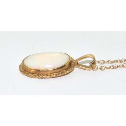 358 - 9ct gold large Opal oval pendant necklace set in a scroll setting on a 46cm gold chain 