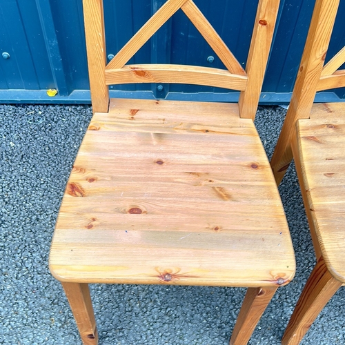 53 - Set of 4 Pine Wooden chairs with a natural finish, featuring a classic cross-back design and sturdy ... 