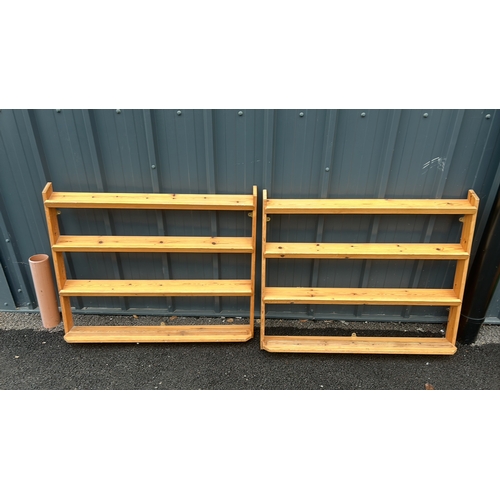 64 - Pair of wooden wall-mounted shelves, featuring three tiers each, crafted from light stained pine.