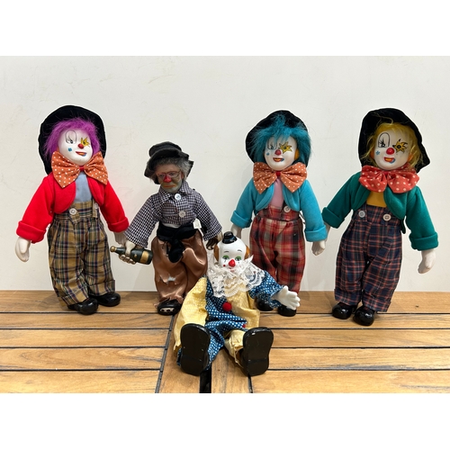 146 - A collection of 5 Large clowns with hand painted porcelain heads, hands and feet