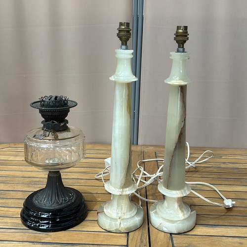 175 - Pair of onyx table lamps with brass fittings, accompanied by a vintage glass oil lamp with decorativ... 