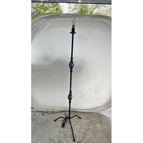 179 - A Tall Black metal floor lamp with tripod base, with intricate design. Good Condition