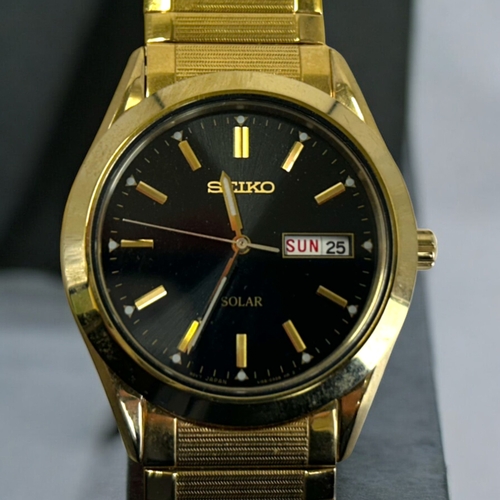 15 - A Seiko Solar mens wristwatch.Gold plated, black dial with day / date.