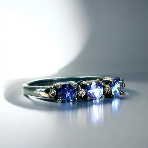 130 - Two ladies Silver and Tanzanite rings. With accent Diamonds.Sizes P & Q.