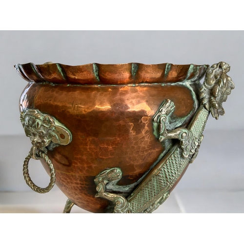 42 - A Chinese Tibetan Copper planter.Circa 1900.Mounted with metal Dragons, looped mask handles and deco... 