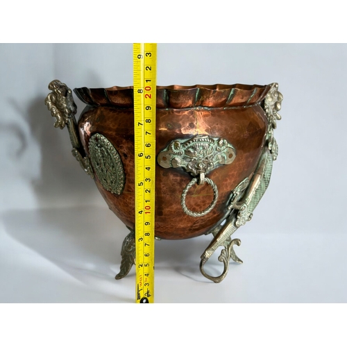 42 - A Chinese Tibetan Copper planter.Circa 1900.Mounted with metal Dragons, looped mask handles and deco... 