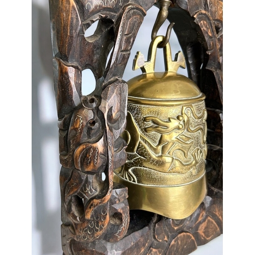 44 - A large Chinese Tibetan carved hardwood temple bell.Carved and inlaid intwined Dragons contesting th... 