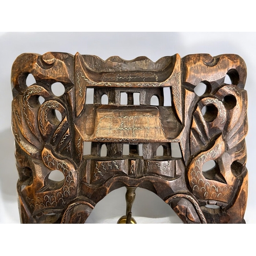 44 - A large Chinese Tibetan carved hardwood temple bell.Carved and inlaid intwined Dragons contesting th... 