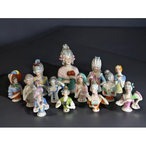 270 - A large collection of antique porcelain 1/2 lace doll toppers.